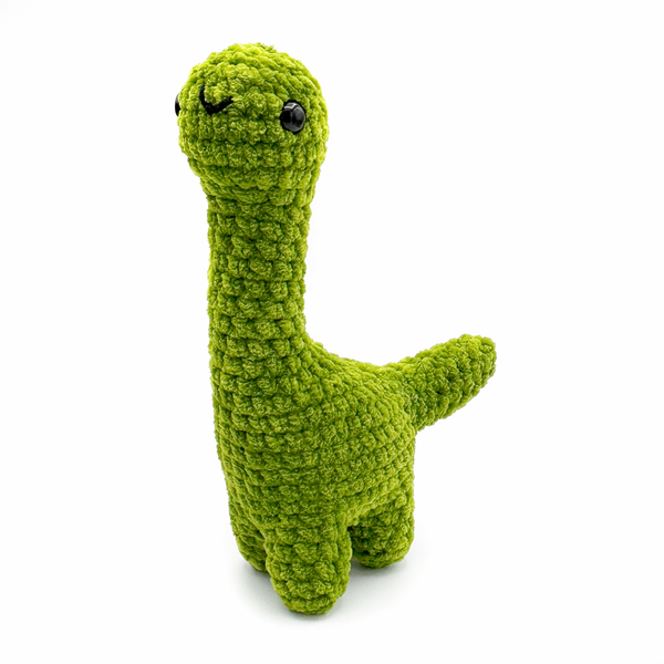 Crochet amigurumi brontosaurus plushie in goblin green