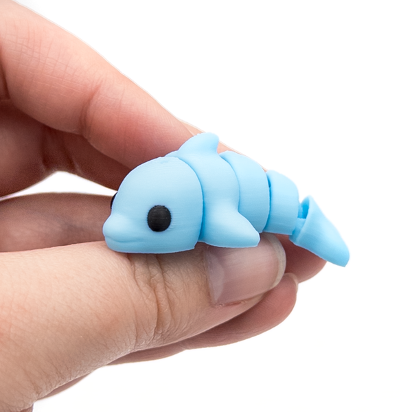 3D printed mini dolphin fidget held in hand