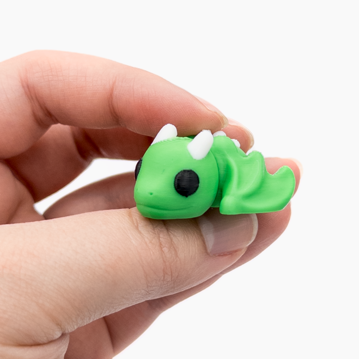 3D printed mini dragon with spread wings fidget creature held in hand