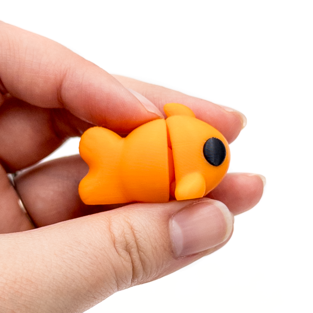 3D printed mini goldfish fidget creature held in hand