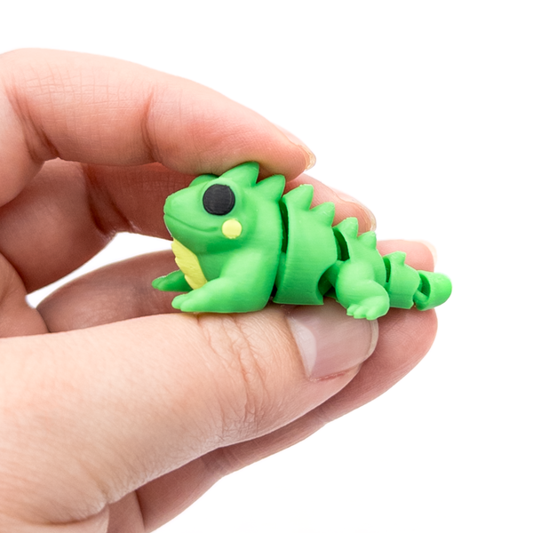 3D printed mini iguana fidget creature held in hand