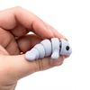 3D printed mini manatee fidget creature held in hand