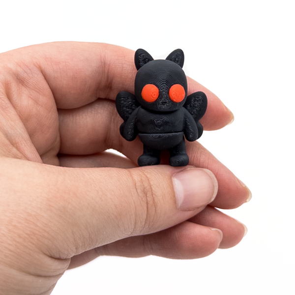 3D printed mini Mothman fidget creature held in hand