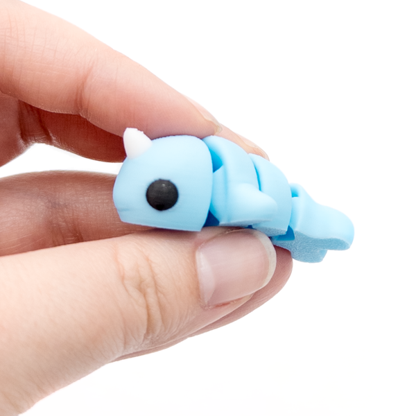 3D printed narwhal mini fidget creature held in hand