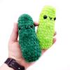2 Crochet Amigurumi Pickles in Emerald and Neon Green held in hand