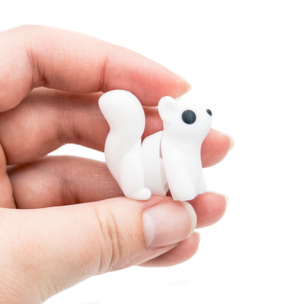 3D printed mini white squirrel fidget creature held in hand