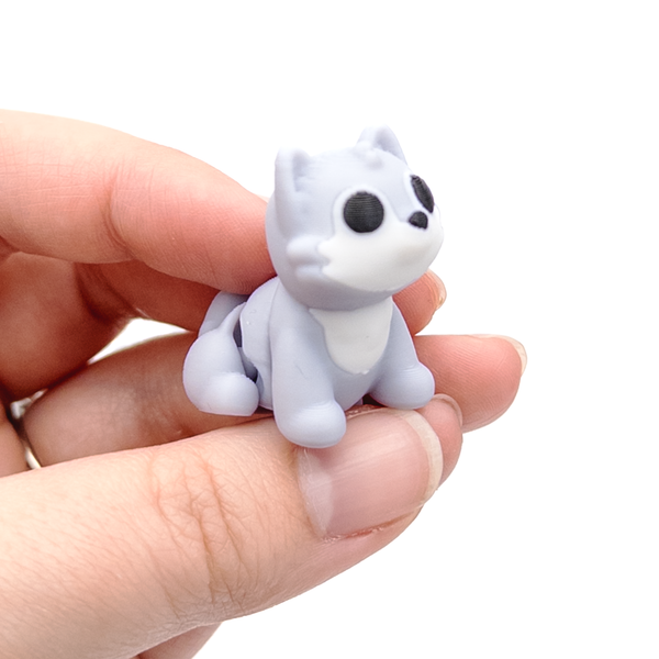 3D printed mini wolf fidget creature held in hand
