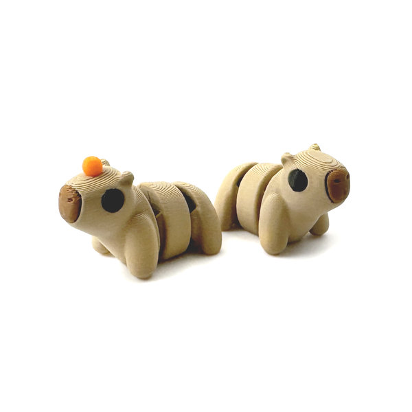 Two 3D Printed Mini Capybara fidgets, one with an orange on its head one without.