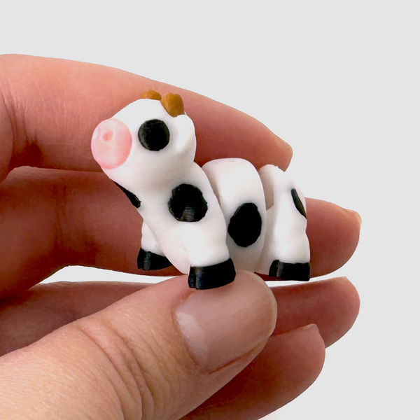 3D printed mini cow fidget held in hand