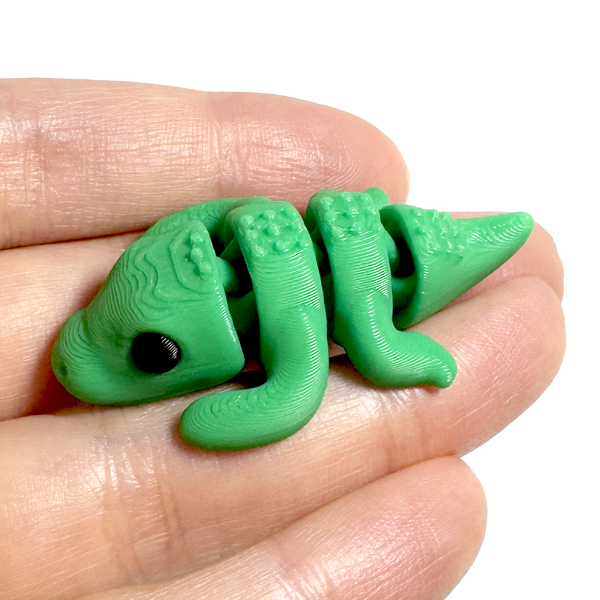 3D printed crocodile/alligator mini fidget creature held in hand