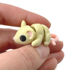 3D printed tan mouse fidget creature held in hand