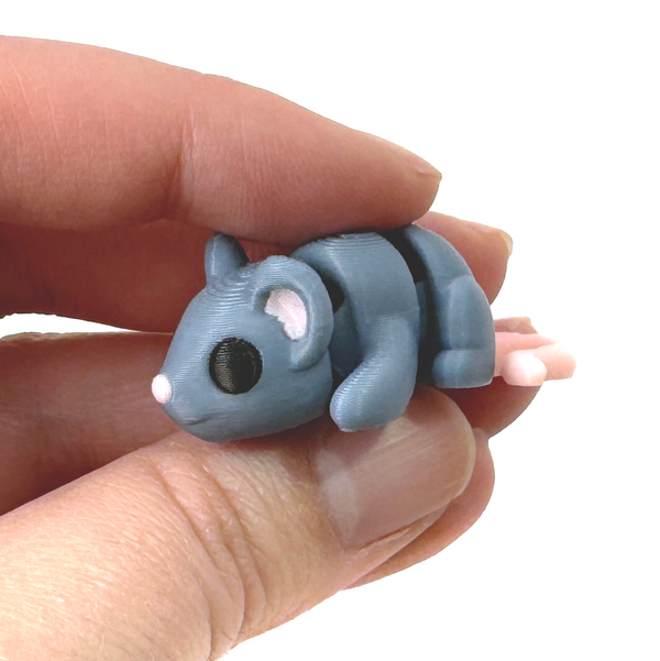 3D printed grey mouse fidget creature held in hand