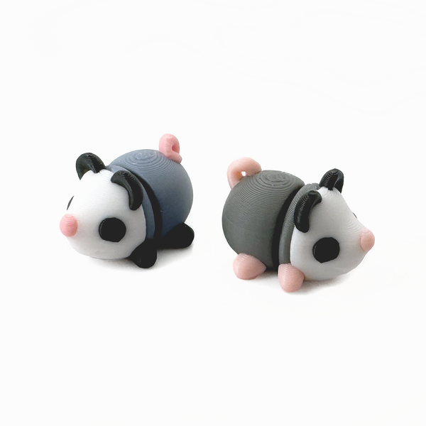 Two 3D printed mini opossum fidget creatures