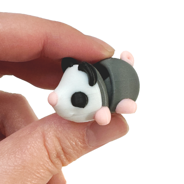 3D printed mini opossum fidget creature held in hand