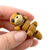3D printed otter mini fidget creature that is belly up and laying on its back held in hand