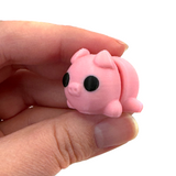 3D printed pig mini fidget creature being held in hand