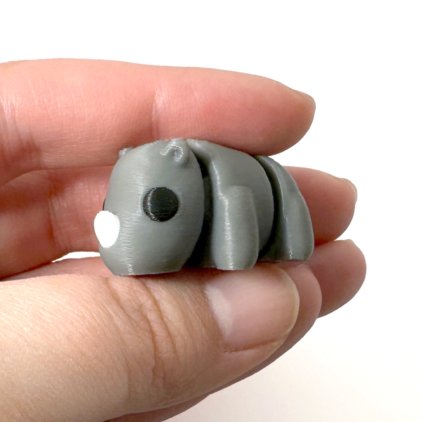 3D printed rhinoceros mini fidget creature being held