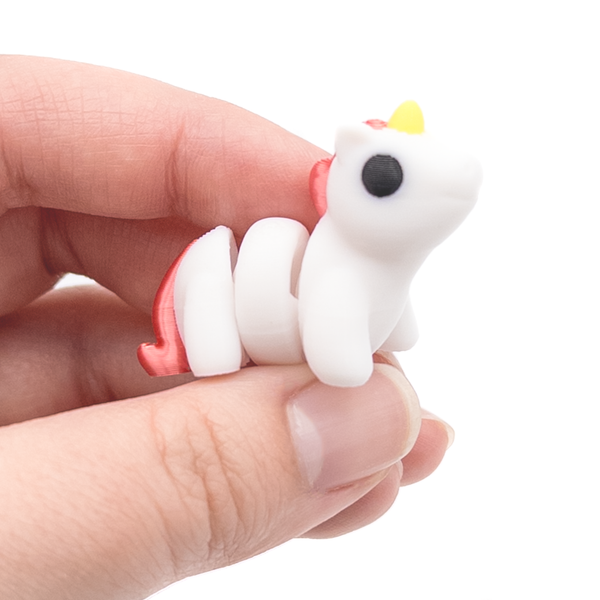 3D printed mini unicorn fidget creature held in hand