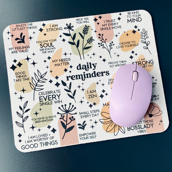 mouse pad with a wireless mouse featuring daily reminders with family friendly language