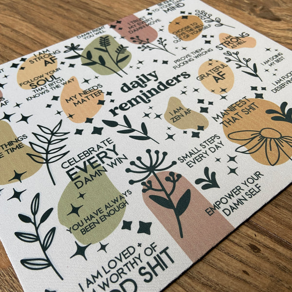 mouse pad featuring daily reminders that include various cuss words