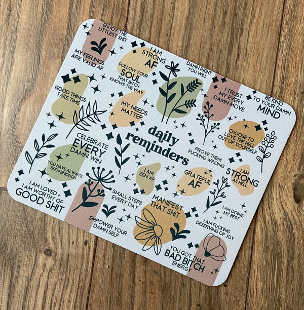 mouse pad featuring daily reminders that include various cuss words