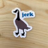 Die cut glossy vinyl sticker with a Canadian goose that says "jerk" on wood background