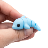 3D printed mini dolphin fidget held in hand