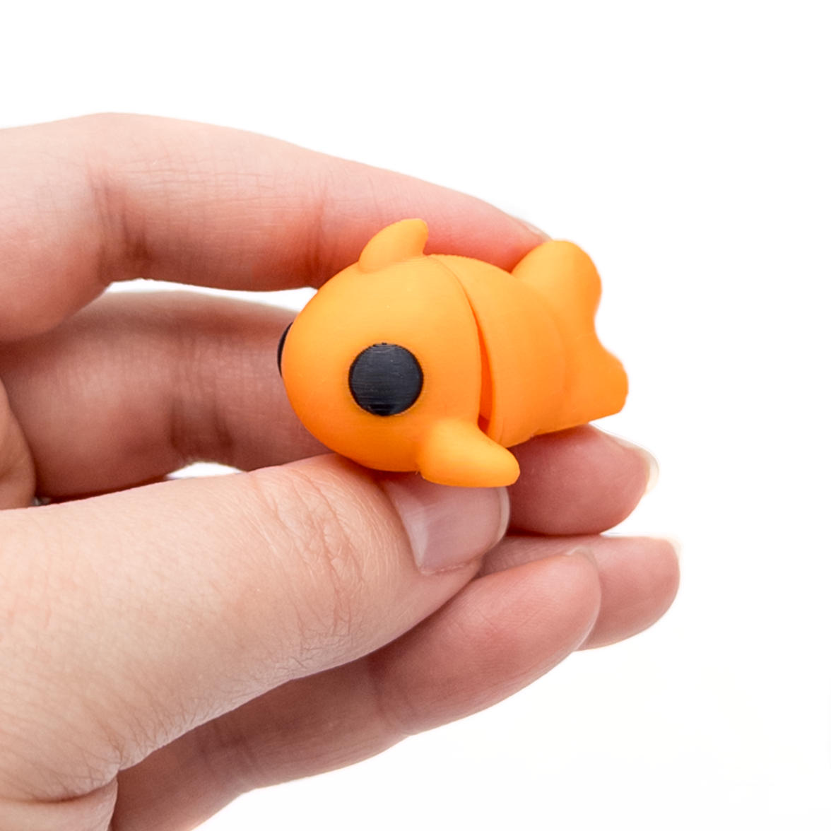 3D printed mini goldfish fidget creature held in hand