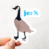 Die cut glossy vinyl sticker with a Canadian goose that says "jerk" being held between thumb and forefinger