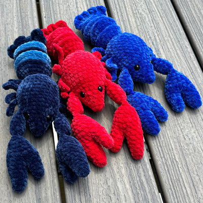 Three amigurumi crochet fidget lobsters