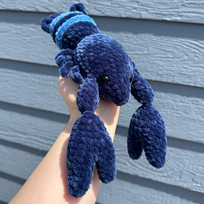 Blue Amigurumi Crochet Lobster being held in hand