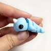 3D printed narwhal mini fidget creature being held