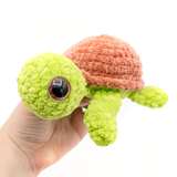 Sea Turtle Crochet Amigurumi Stuffed Animal held in hand featuring glitter safety eyes
