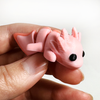 3D printed axolotl mini fidget creature being held