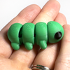 3D printed caterpillar mini fidget creature being held