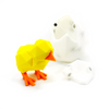 3D printed chick and egg magnet puzzle with chick standing next to egg which has one piece missing from top