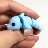 3D printed dolphin mini fidget creature being held