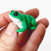 3D printed bright green frog with white underbelly mini fidget creature being held