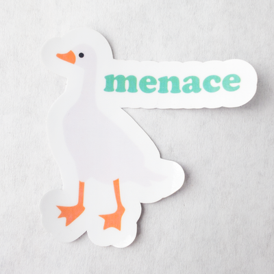 Die cut glossy vinyl sticker with a white goose that says "menace"