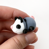 3D printed opossum with black feet mini fidget creature being held