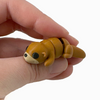 3D printed otter mini fidget creature that is belly down and on all fours being held