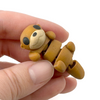 3D printed otter mini fidget creatures that is belly up and laying on its back being held