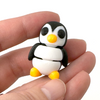 3D printed penguin mini fidget creature being held