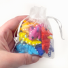 Pouch of 8 mini fidget creature dragons of all different colors being held