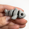 3D printed shark mini fidget creature being held