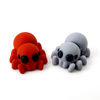 Two 3D printed spider mini fidget creatures - one in red and one in light gray