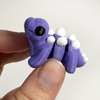 3D printed stegosaurus dinosaur mini fidget creature being held