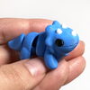 3D printed triceratops dinosaur mini fidget creature being held