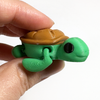 3D printed sea turtle mini fidget creature being held